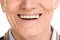 Close-up on cheerful senior man smiling