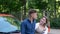 Close up of cheerful young couple man and woman smiling feeling happy with a new car. Caucasian man holding in hand and