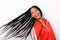 Close up cheerful young girl in red jacket and long braided hair on white background