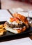 Close up Cheeseburger with grilled beef, feta cheese and sliced tomato served with fries in black plate