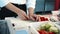 Close-up: The chef adds chopped peppers to the pot. The process of preparing food in a restaurant