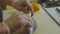 Close-up of a chef cuts dorado fish on a cutting board in a restaurant kitchen.