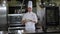 Close-up of the chef holding a plate of grilled fish and vegetables in kitchen