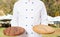 Close up chef holding wooden board boards in the kitchen street