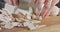 Close up of a chef knife slicing champignon mushrooms