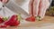 Close up of a chef knife slicing a Strawberry