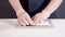 Close up of chef male hands in gloves cooking sushi rolls in the kitchen.