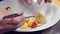 Close up chef plating salad tweezers restaurant kitchen