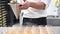 Close up of Chef pouring apricot jam to glass bowl