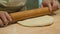 Close up of chef in the restaurants` open kitchen preparing dough for traditional ossetian pie