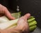 Close up of a chef rinsing a leek under cold running water