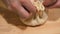 Close-up of the chef's hands cooking khinkali with meat and herbs in a restaurant. The chef prepares traditional