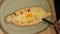 Close-up of the chef's hands cooking traditional khachapuri in Adjarian style. Khachapuri is smeared with oil