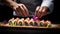 Close up of a chef\\\'s hands decorating sushi roll