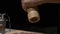 Close-up of a chef`s hands grinding pepper with a pepper mill