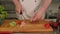 Close-up of the chef slicing chicken meat and vegetables on a cutting Board.