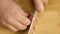 Close-up of chef slicing sausages. Stock footage. Chef cuts slices of juicy pink sausage pizza on wooden board. In