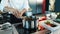 Close-up: The chef stirs the ingredients into a saucepan. The process of preparing food in a restaurant