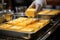 Close-up of a chef taking a melted piece of cheese from a large pan, kitchen in a hotel complex.