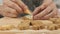 Close up of Chef writing sugar cream on Christmas homemade gingerbread cookies