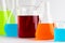 Close up of chemistry beakers and dishes with liquid and copy space on white background