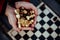 Close up of chess pieces in hands of unrecognizable woman. Unknown female holds figures of chess in her hands.