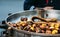 Close up of chestnuts on a pan with a salesman