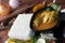 Close up of a chicken curry with vegetable, herb and spices on a wooden table and white napkin