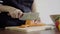 Close up of chief woman making salad healthy food and chopping carrot on cutting board in the kitchen.