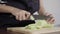 Close up of chief woman making salad healthy food and chopping cucumber on cutting board