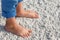 Close up of child feet on a tropical sandy beach