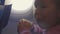 Close-up child girl eat burger with appetite over porthole in airplane