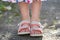 Close up of child girl feet wearing summer sandals shoes