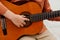 Close-up, child hand with guitar, outdoor, classic guitar