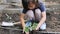 Close up of child hand planting a seedling in the backyard. Child growing vegetables in the kitchen garden.