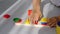 Close-up of child is hands folds a wooden logical toy. Baby collects a wooden pyramid . Educational logical toys for children.