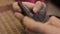 Close-up child hands with a phone, teenage using her smartphone for playing