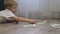 Close-up of a child playing with dominoes at home on the floor.