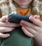 close-up of a child playing with a smartphone, very close-up of hand and mobile phone