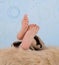 Close-up of a child\'s feet over furry blanket