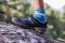 Close-up child\\\'s feet walk along the log of a fallen tree.