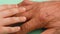 Close-up of a child`s hand stroking a wrinkled elderly man`s hand. Taking care of elderly relatives. friendship of grandson and gr