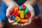 Close-up of a child\\\'s hands holding colorful building blocks, symbolizing creativity and early development
