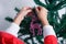 Close-up of child`s hands putting reindeer-shaped Christmas ornament