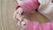 Close-up of a child's hands with wooden wheels for a toy