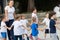 Close up of children group warming up and preparing for the main part of lesson.  Sport school