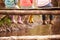 Close Up Of Children\'s Feet Dangling From Wooden Bridge