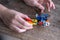 Close-up of children\'s hands creating construction from pieces, figure of robot mountaineer, Engineering Education, Learning