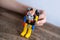 Close-up of children\'s hands creating construction from pieces, figure of robot mountaineer, Engineering Education, Learning