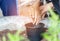 Close up children and woman`s hand transplanting plant and soil into a pots